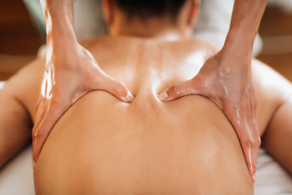 Focused pressure along the upper back during a massage