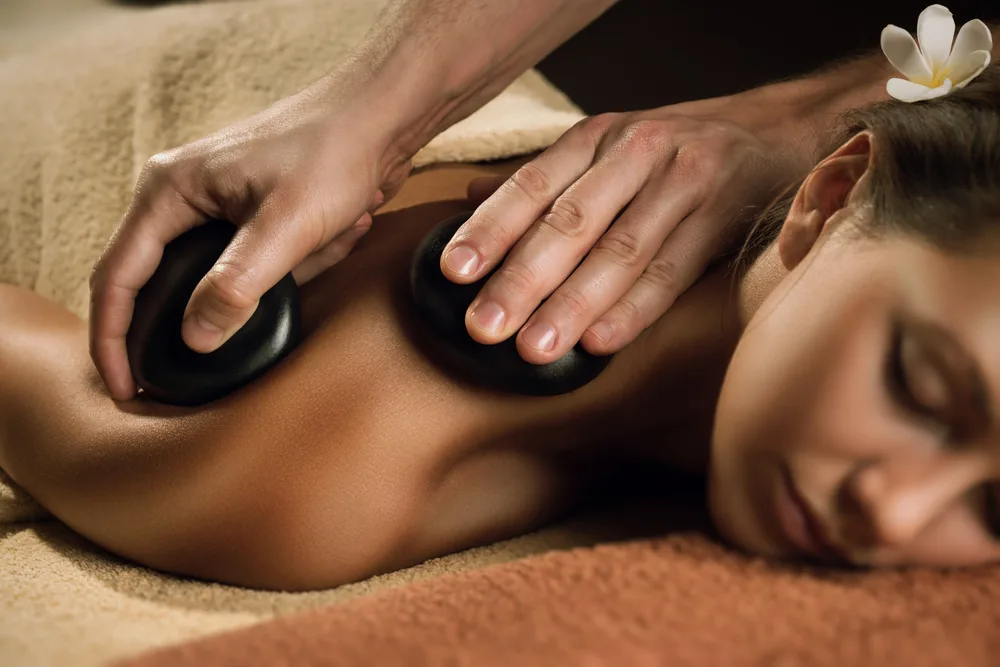 Warm smooth stones used during a relaxing back massage